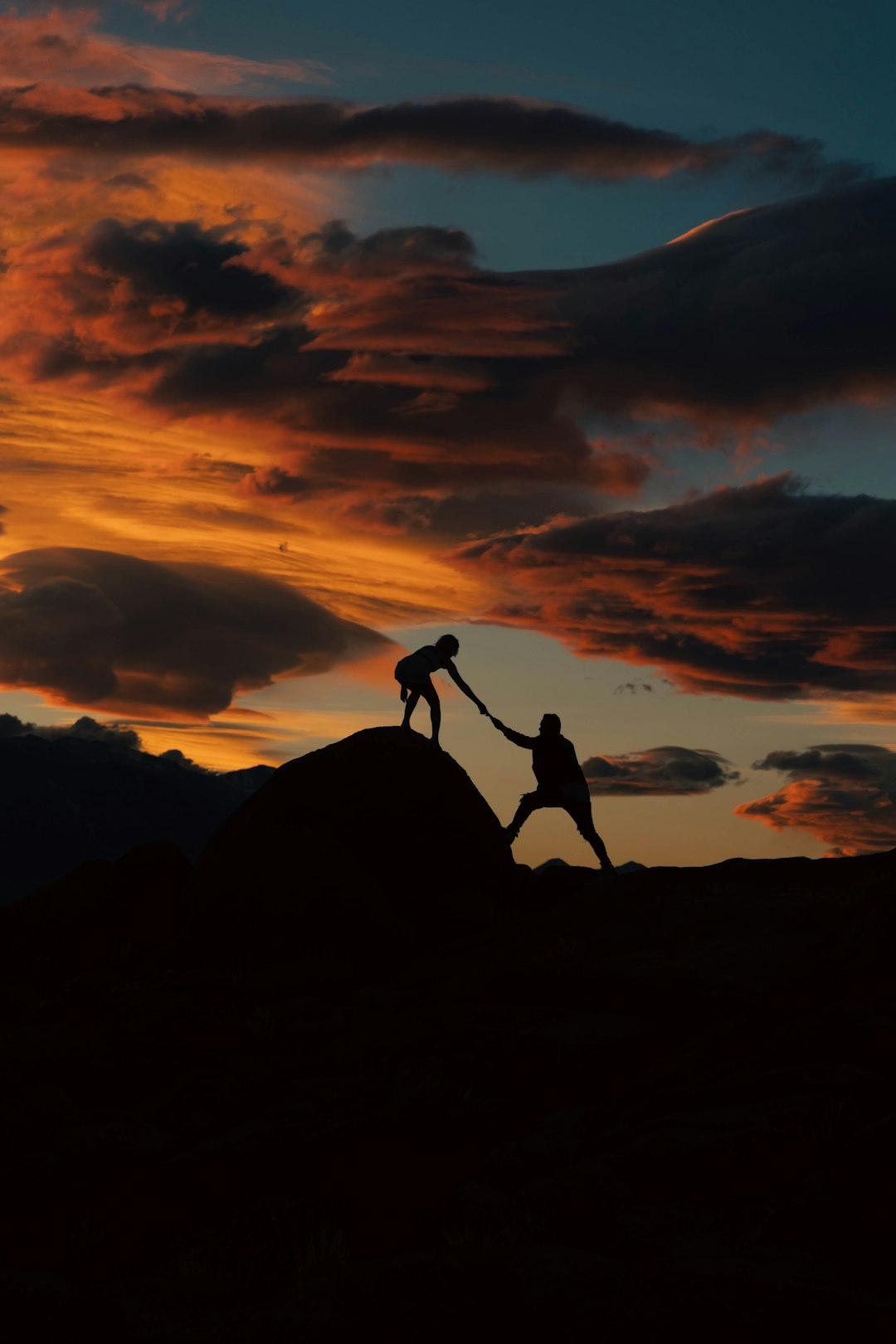 a-couple-of-people-holding-hands-on-top-of-a-hill-hynxiq1np0e