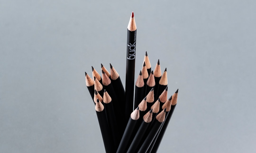a-group-of-black-pencils-with-one-standing-tall-hangphvwifa