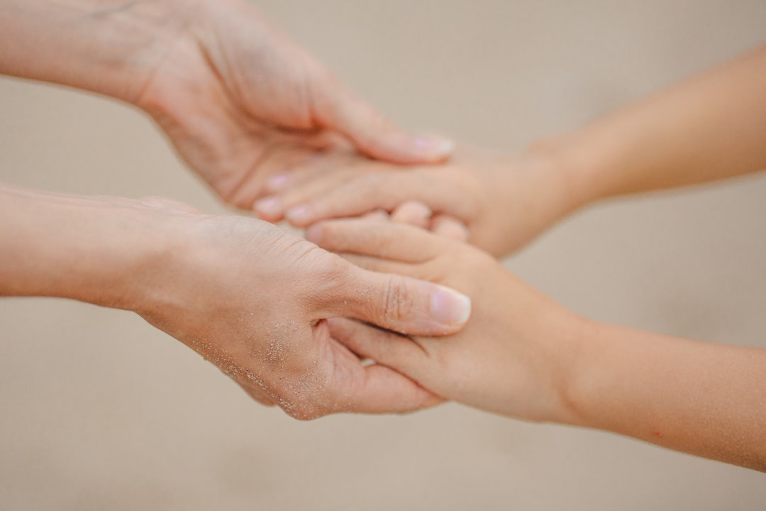 Gentle hands of a mother and child holding each other